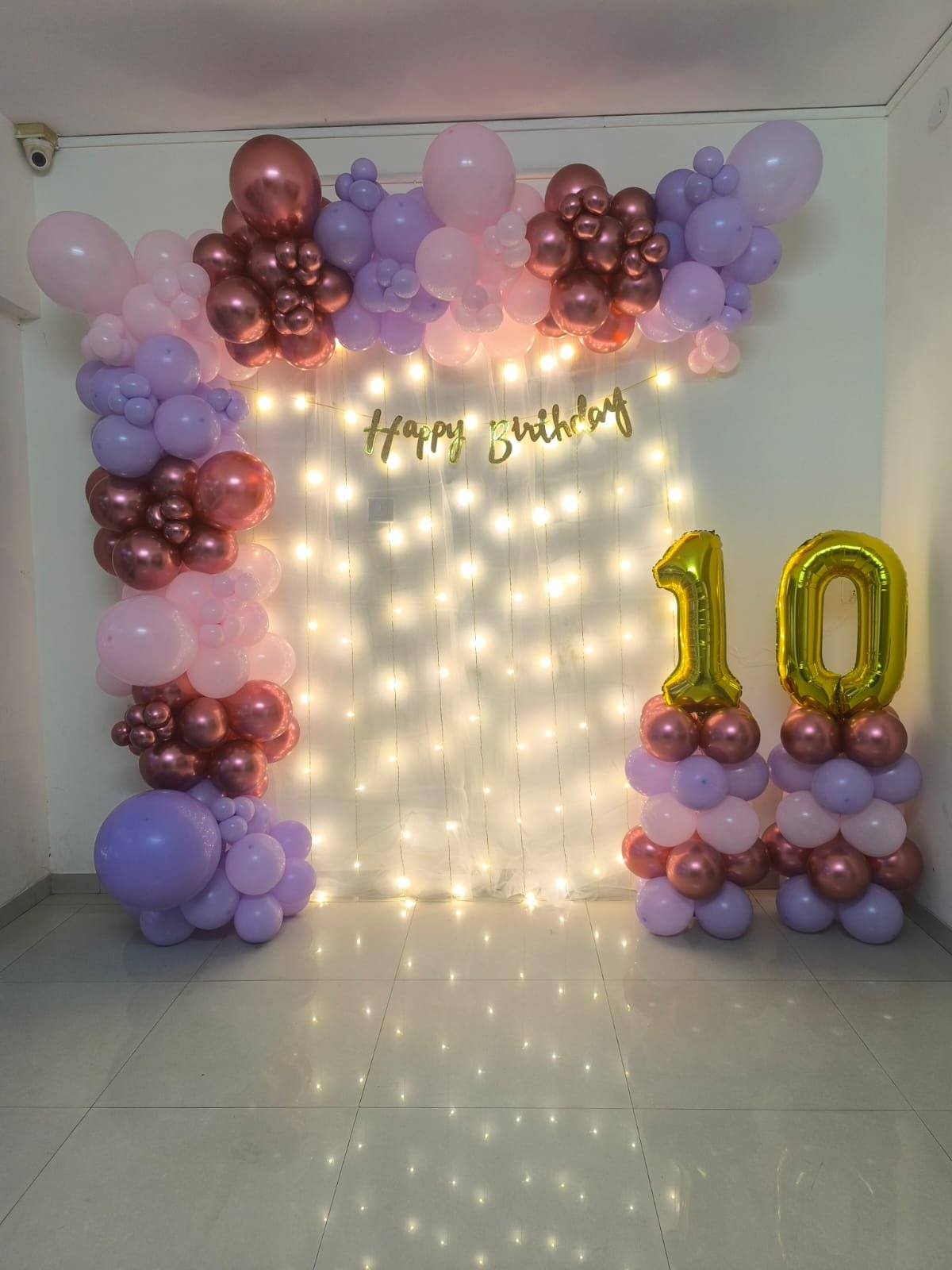 Pastel pink and rose gold balloon home decoration with fairy light curtain by Star Balloon