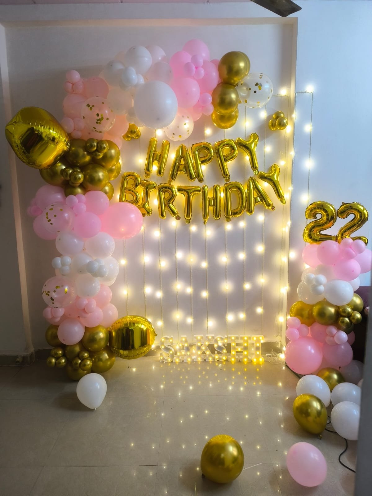 Pink and gold birthday balloon backdrop with fairy lights by Star Balloon